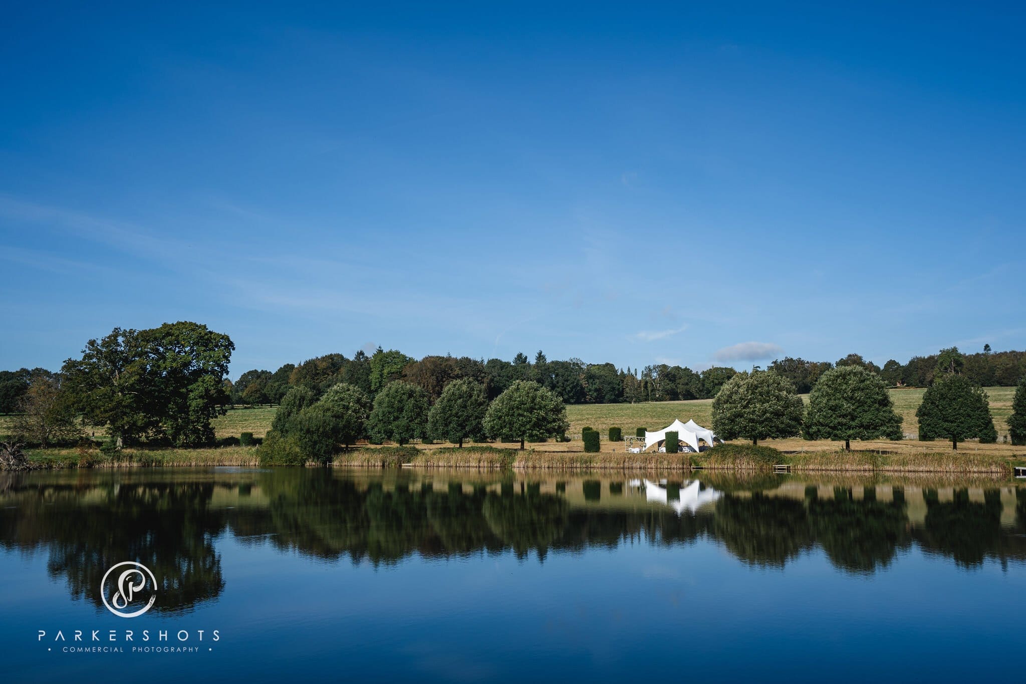 View across lake of wedding ceremony area at Penshurst Place