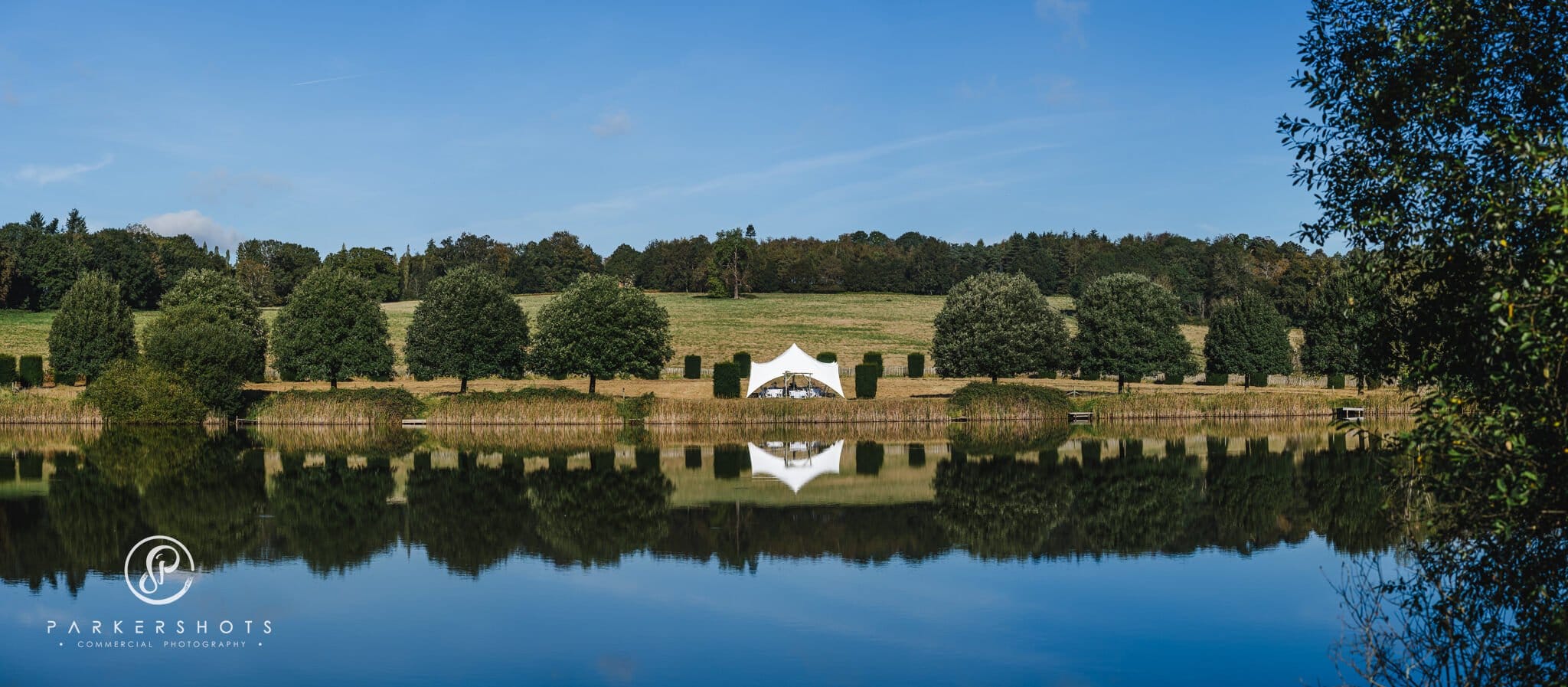 View across lake of wedding ceremony area at Penshurst Place